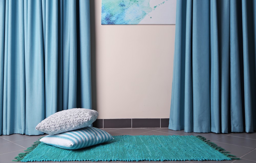 blue curtains on grey tiles