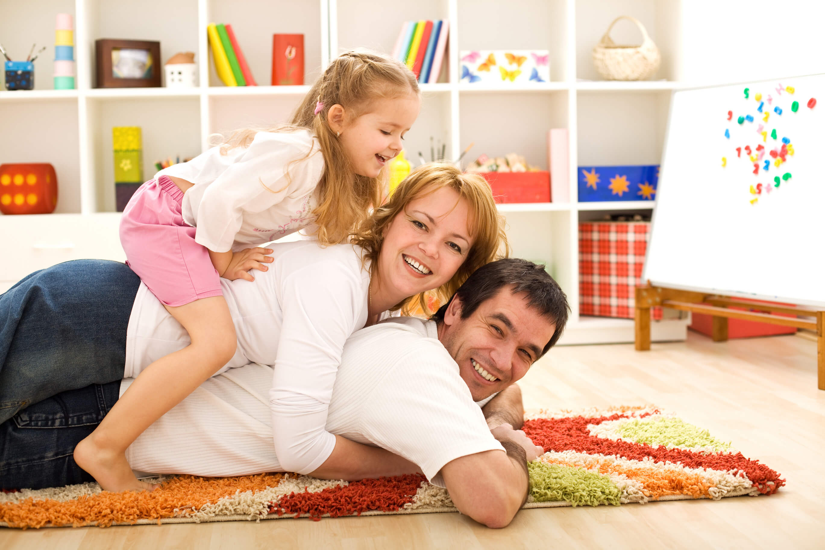 family on rug in playroom