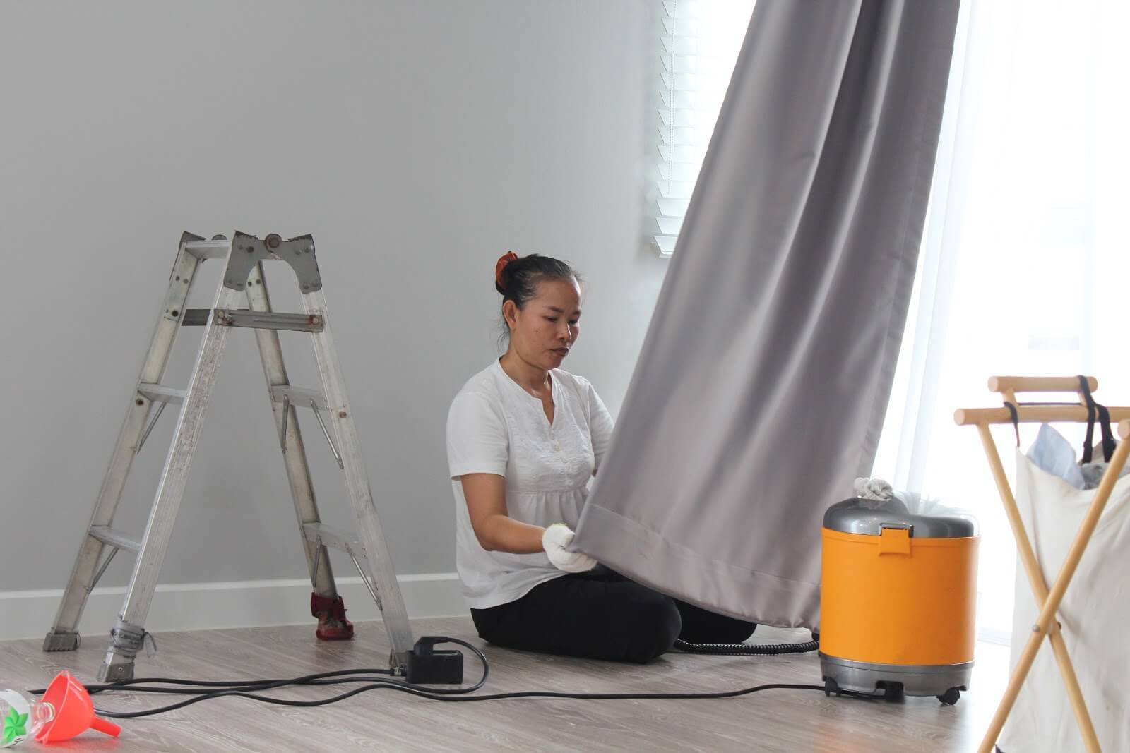 woman cleaning curtains